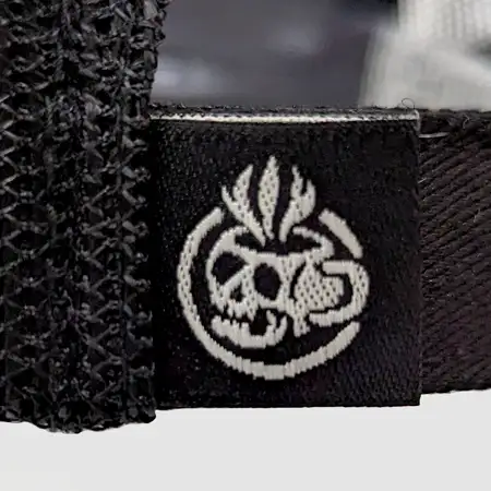 Photo of a woven loop label attached to the back vent of a cap