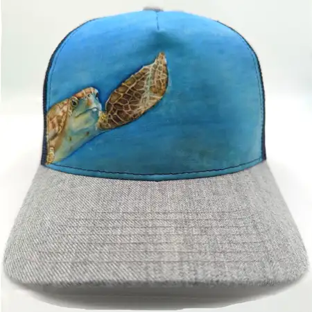 Photo of a 5 panel cap with a turtle illustration sublimated on the entire front panel