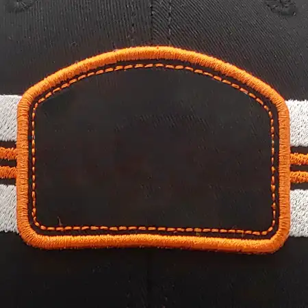 Photo of a blank black soot fabric patch with an orange chain and cover stitch